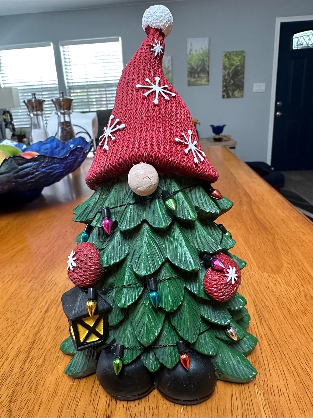 Christmas tree gnome. Green Christmas tree with red hat and mittens and lights
